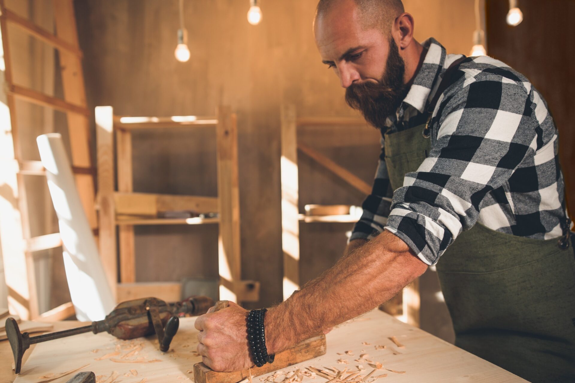 Portrait of a young male carpenter who works in his workshop